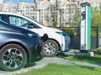 Two charging electric cars at charge station in the city